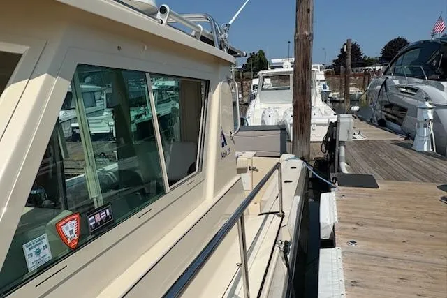 Slide: The Image of 2003 Albin 28 Tournament Express docked at a marina, showcasing its side view and cabin. - 7