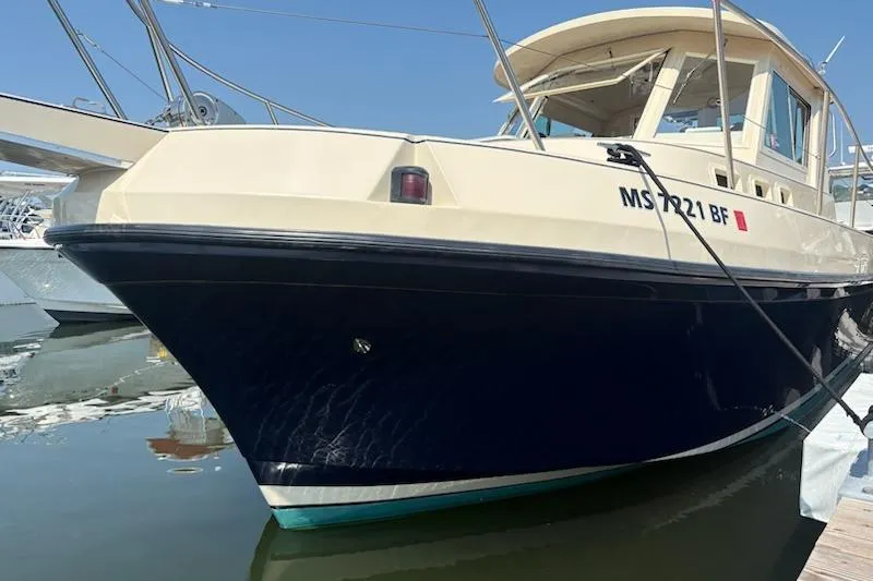 Slide: The Image of 2003 Albin 28 Tournament Express boat docked in marina, side view. - 9