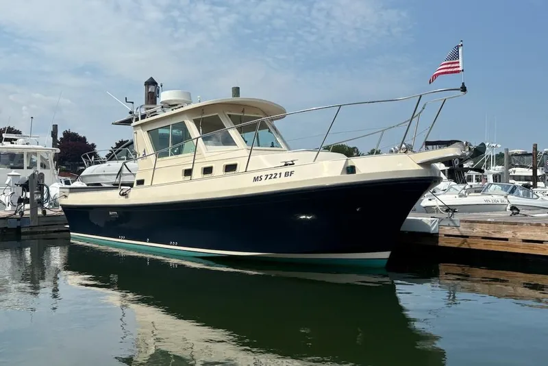 Slide: The Image of 2003 Albin 28 Tournament Express boat docked with American flag. - 28