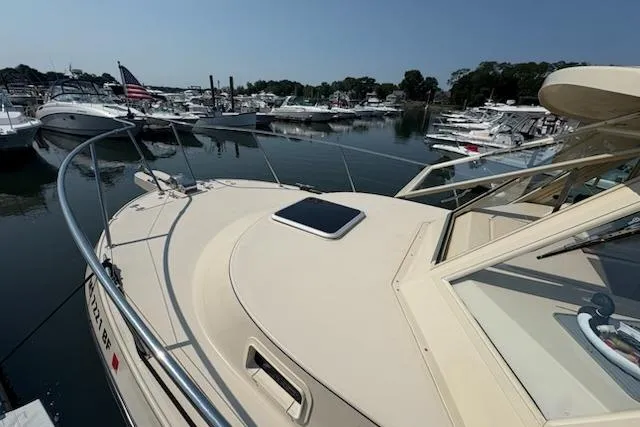 Slide: The Image of 2003 Albin 28 Tournament Express boat docked in a marina, surrounded by other vessels. - 6