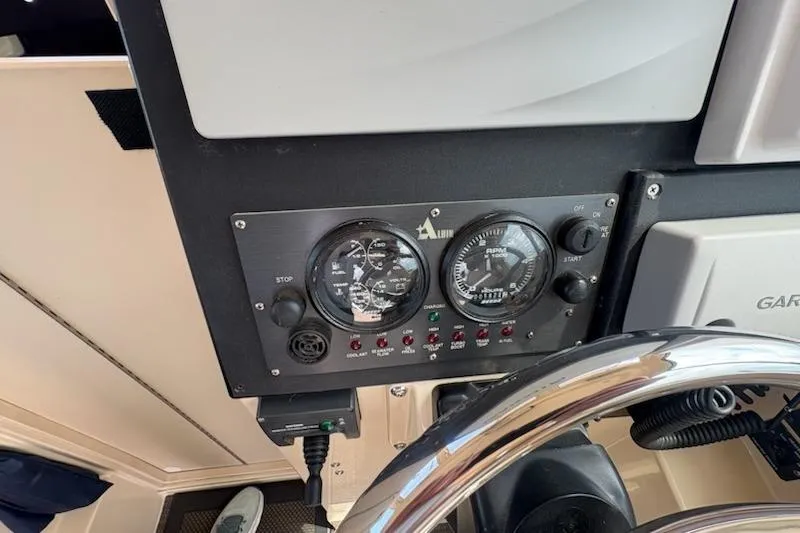 Slide: The Image of Control panel of a 2003 Albin 28 Tournament Express boat with gauges and switches. - 22