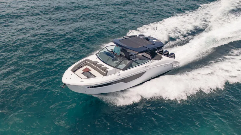 Slide: The Image of 2021 Cruisers Yachts 38 GLS speeding on open water, showcasing sleek design and performance. - 10