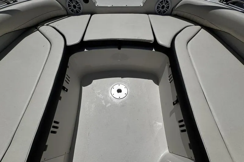 Slide: The Image of 2022 Stingray 212 SC boat interior with cushioned seating and speaker system. - 15