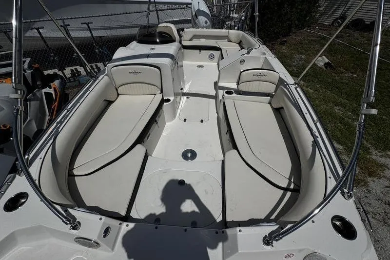 Slide: The Image of 2022 Stingray 212 SC boat interior with spacious seating and sleek design. - 8