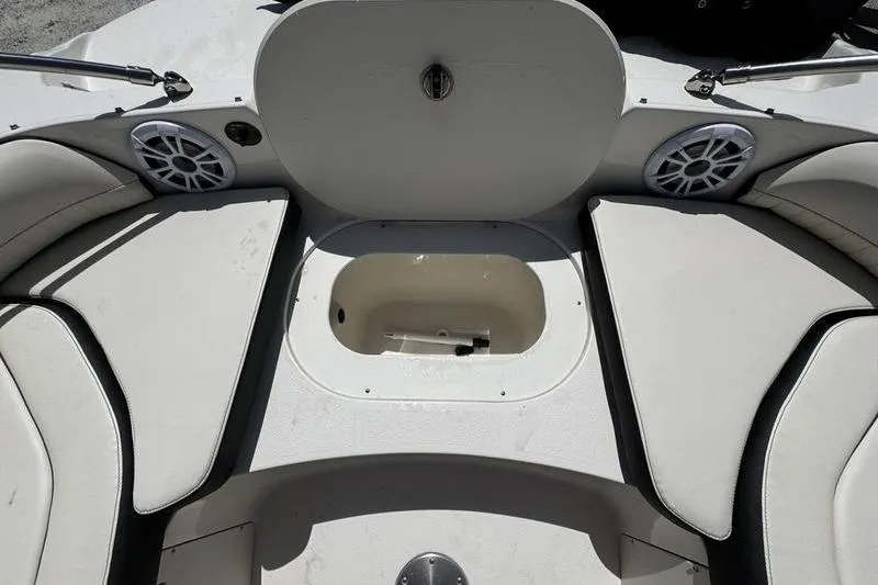Slide: The Image of 2022 Stingray 212 SC boat interior with seating and storage compartment. - 10