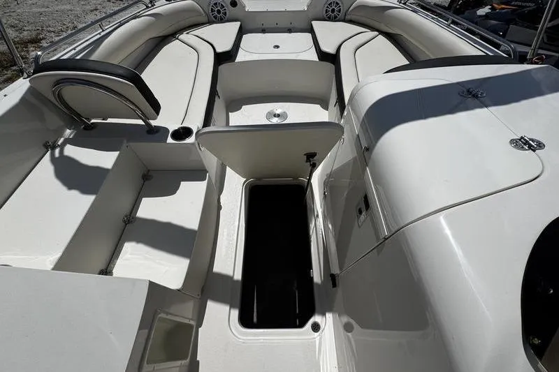 Slide: The Image of 2022 Stingray 212 SC boat interior with open storage compartment and seating. - 14