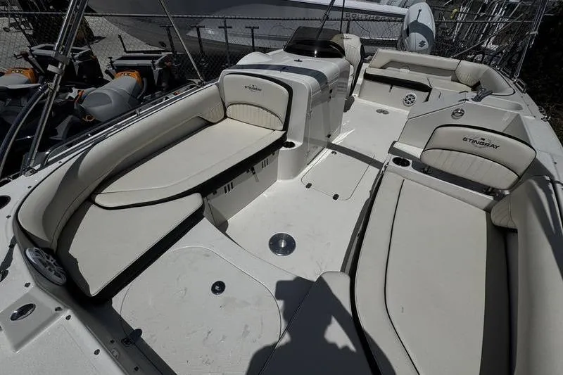 Slide: The Image of 2022 Stingray 212 SC boat interior with spacious seating and modern design. - 9