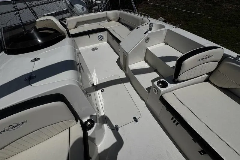 Slide: The Image of 2022 Stingray 212 SC boat interior with spacious seating and modern design. - 12