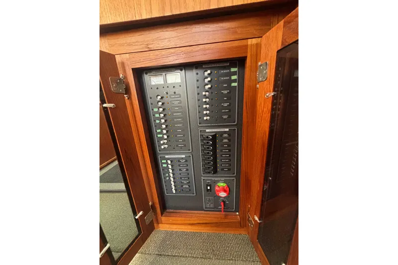 Slide: The Image of Electrical panel inside a 2004 Nordic Tug 37, featuring switches and gauges. - 6