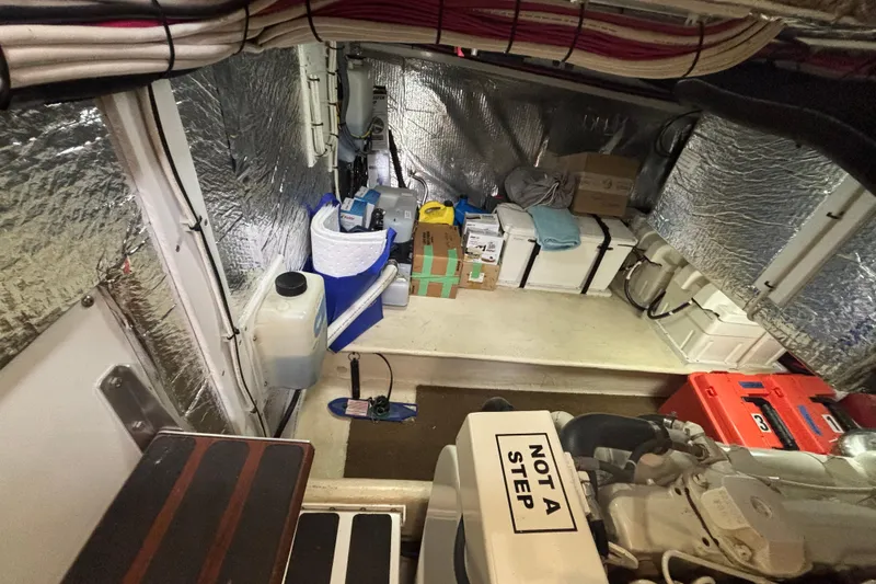 Slide: The Image of Engine room of a 2004 Nordic Tug 37, featuring organized storage and equipment. - 25