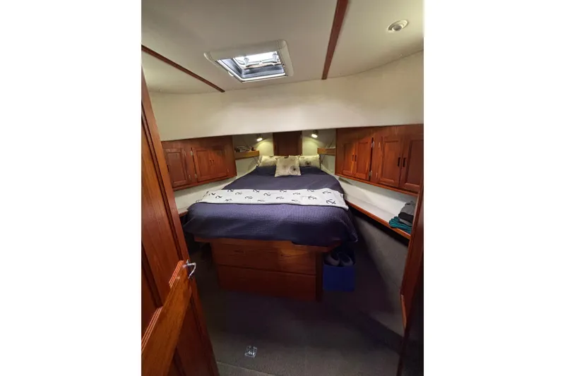 Slide: The Image of Cozy cabin interior of a 2004 Nordic Tug 37 with wooden cabinetry and a skylight. - 17
