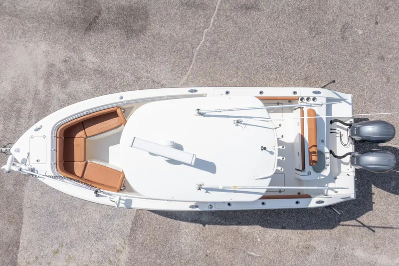 Slide: The Image of 2017 Cobia 261 Center Console boat, aerial view, showcasing spacious deck and dual engines. - 6