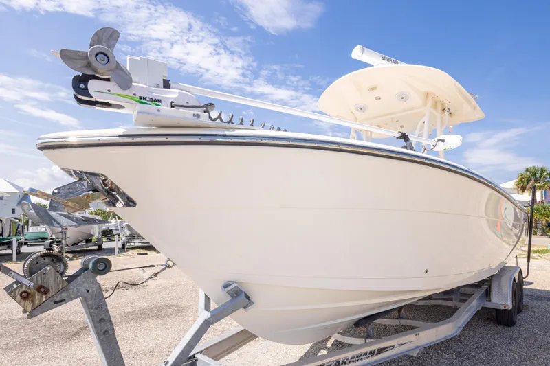 Slide: The Image of 2017 Cobia 261 Center Console boat on trailer under clear blue sky. - 10