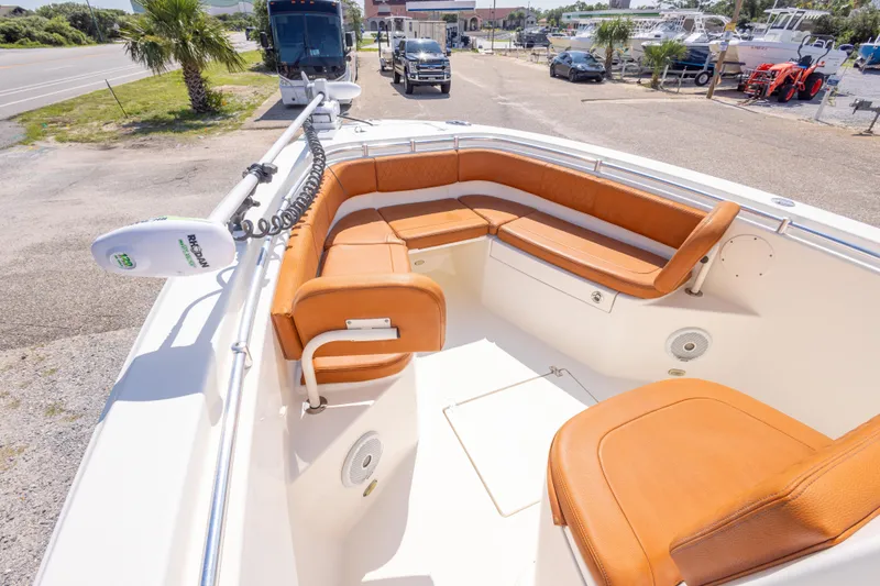 Slide: The Image of 2017 Cobia 261 Center Console boat with tan seating and trolling motor. - 27