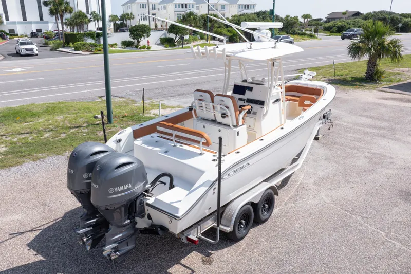 Slide: The Image of 2017 Cobia 261 Center Console boat with dual Yamaha engines on a trailer. - 13