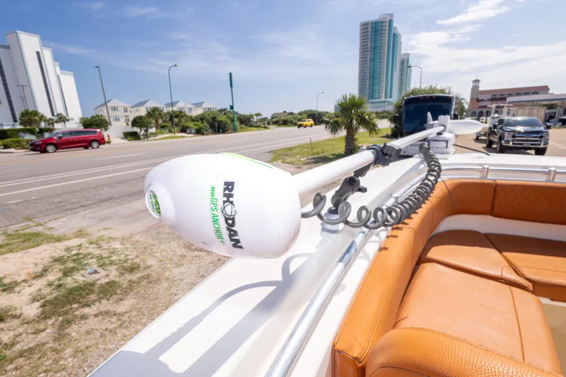 Slide: The Image of 2017 Cobia 261 Center Console with Rhodan GPS Anchor, parked near a coastal road. - 36