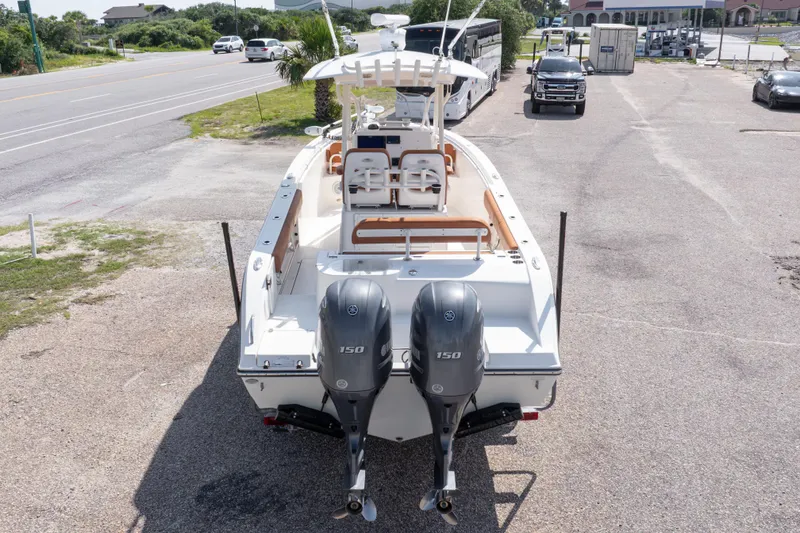 Slide: The Image of 2017 Cobia 261 Center Console boat with dual Yamaha 150 engines, parked on a lot. - 14