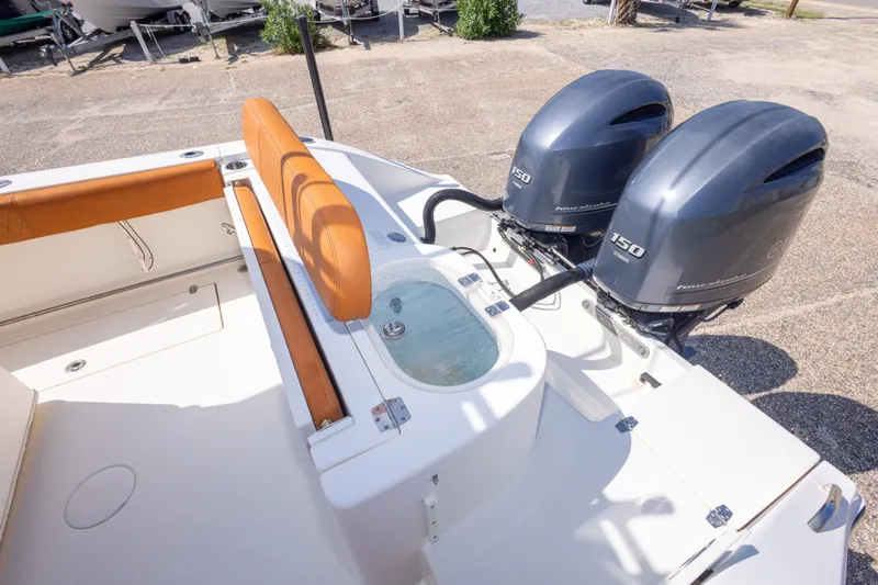 Slide: The Image of 2017 Cobia 261 Center Console boat with twin 150 horsepower engines and seating area. - 48