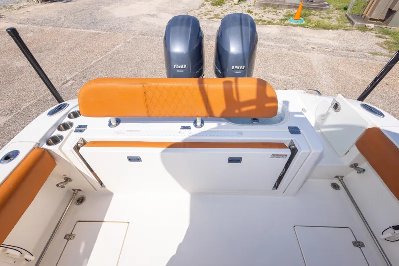 Slide: The Image of 2017 Cobia 261 Center Console boat with twin 150 engines and orange seating. - 47