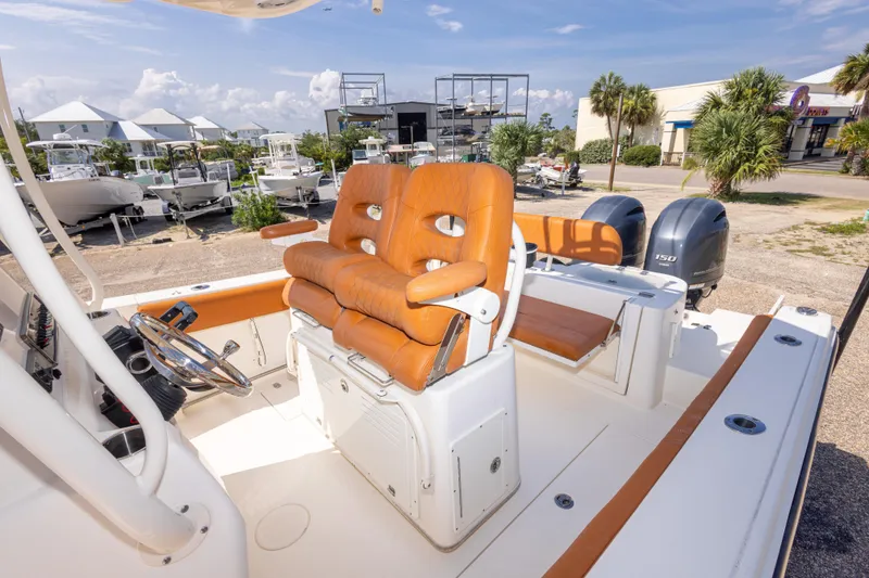 Slide: The Image of 2017 Cobia 261 Center Console boat with orange seating and dual engines. - 40