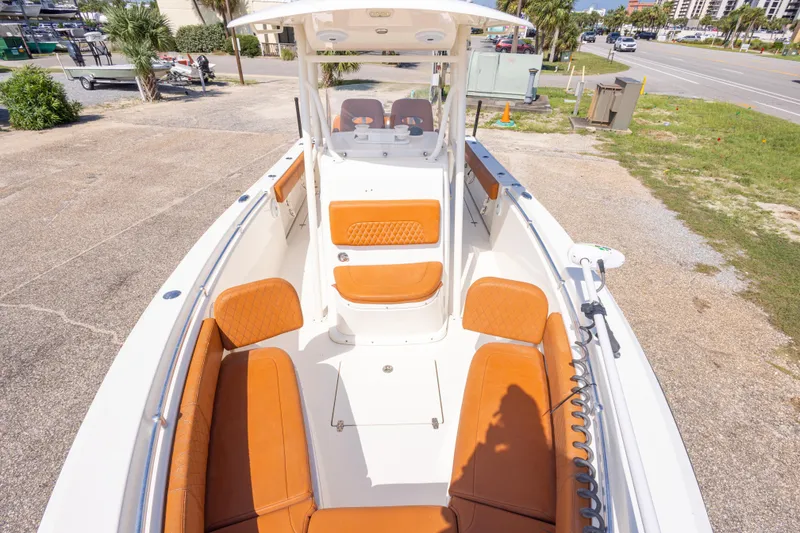 Slide: The Image of 2017 Cobia 261 Center Console boat with tan seating, docked on a sunny day. - 30