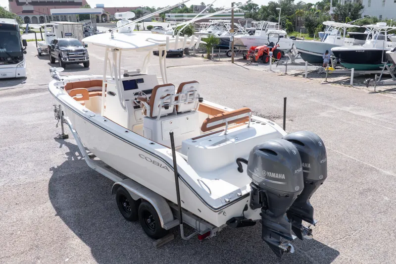 Slide: The Image of 2017 Cobia 261 Center Console boat with dual Yamaha engines on a trailer. - 15