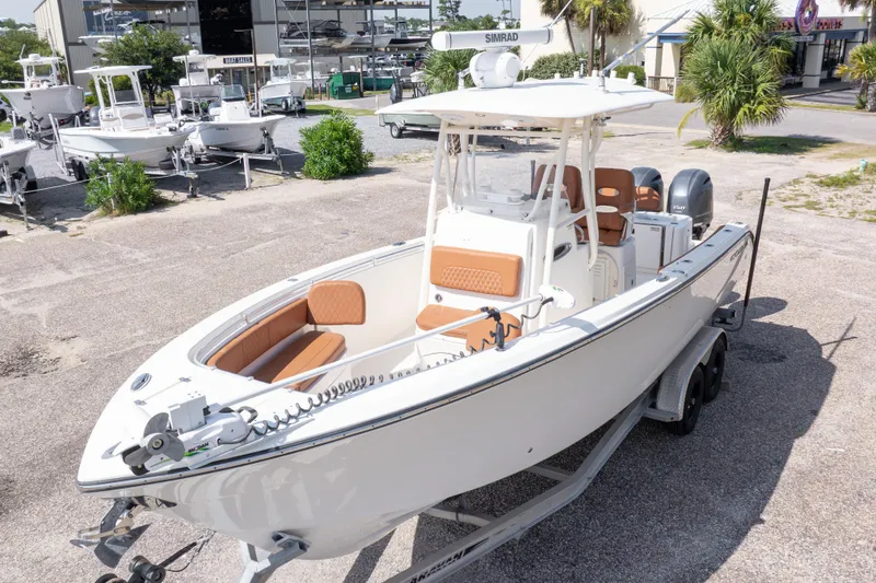 Slide: The Image of 2017 Cobia 261 Center Console boat on trailer, parked outdoors at a marina. - 4
