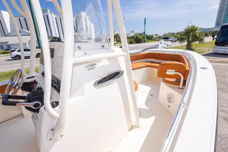 Slide: The Image of 2017 Cobia 261 Center Console boat with tan seating, parked near a road. - 25
