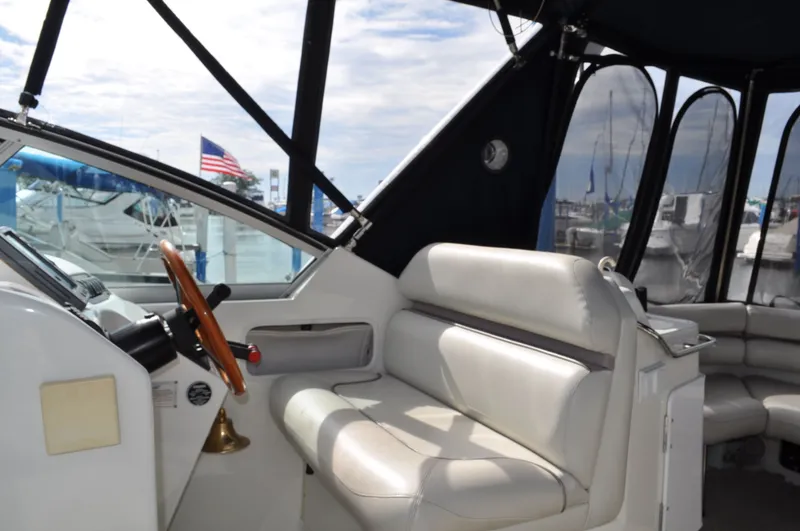 Slide: The Image of The image shows the cockpit of a 1999 Doral 350sc with white seating and a wooden steering wheel. - 8