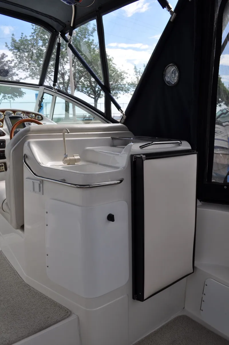 Slide: The Image of The image shows the cockpit of a 1999 Doral 350sc with a sink and refrigerator. - 14