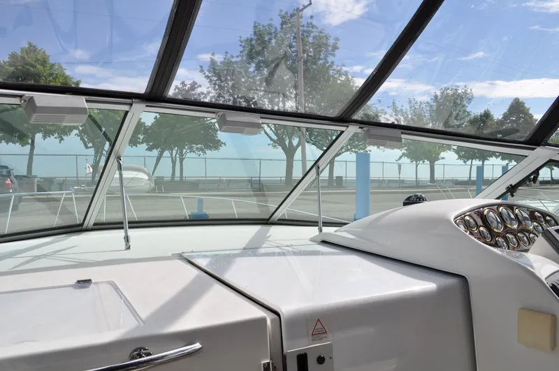 Slide: The Image of The cockpit of a 1999 Doral 350sc overlooking a parking lot and trees. - 7