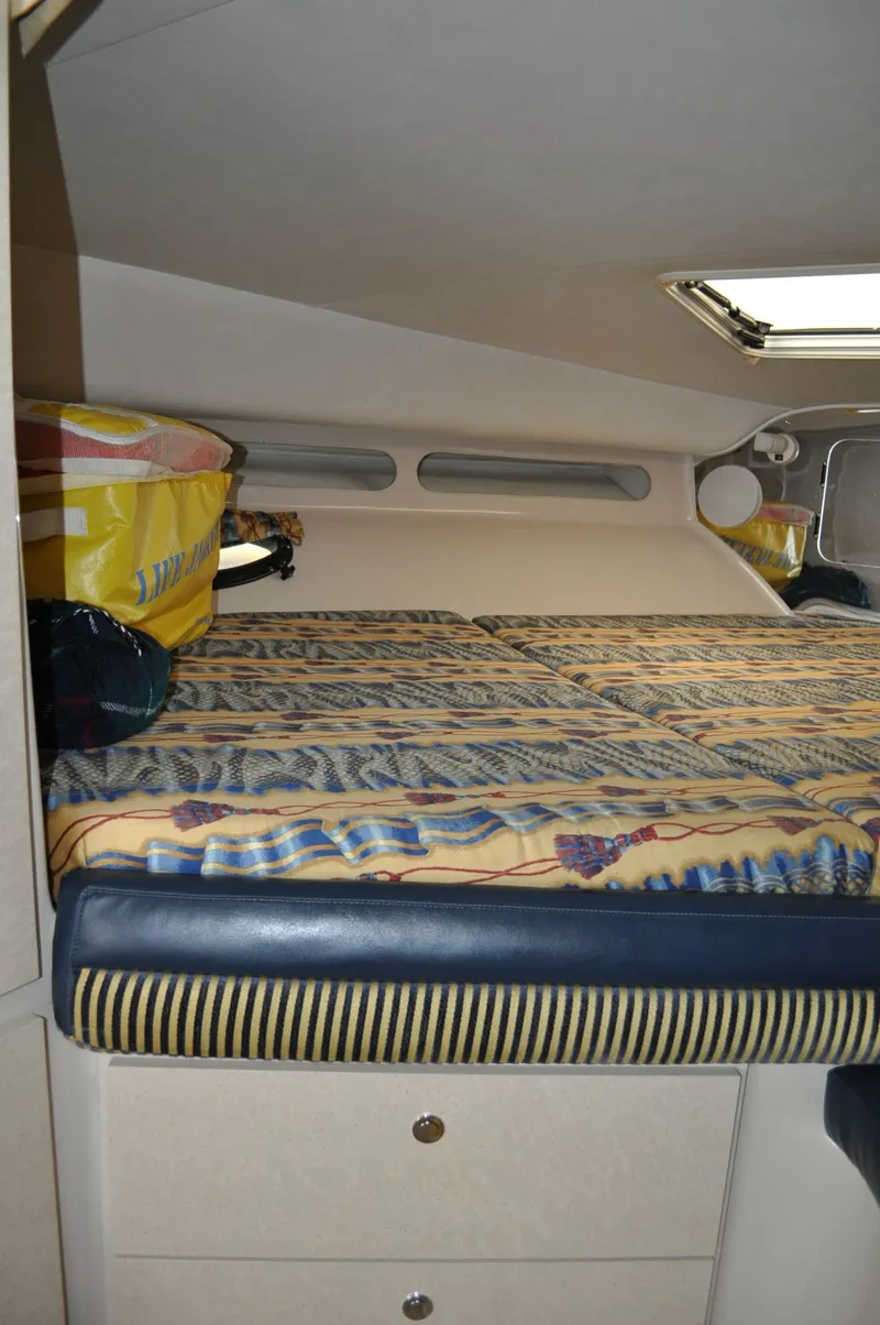 Slide: The Image of Cabin with a bed, striped mattress, and storage drawers underneath. - 18