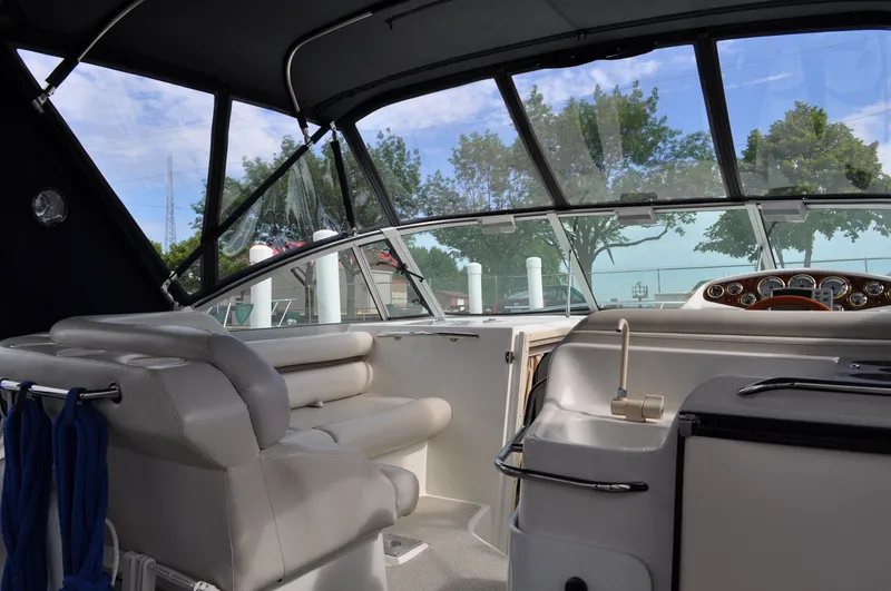 Slide: The Image of The image shows the cockpit of a 1999 Doral 350sc with white leather seats and a clear view of the water. - 12