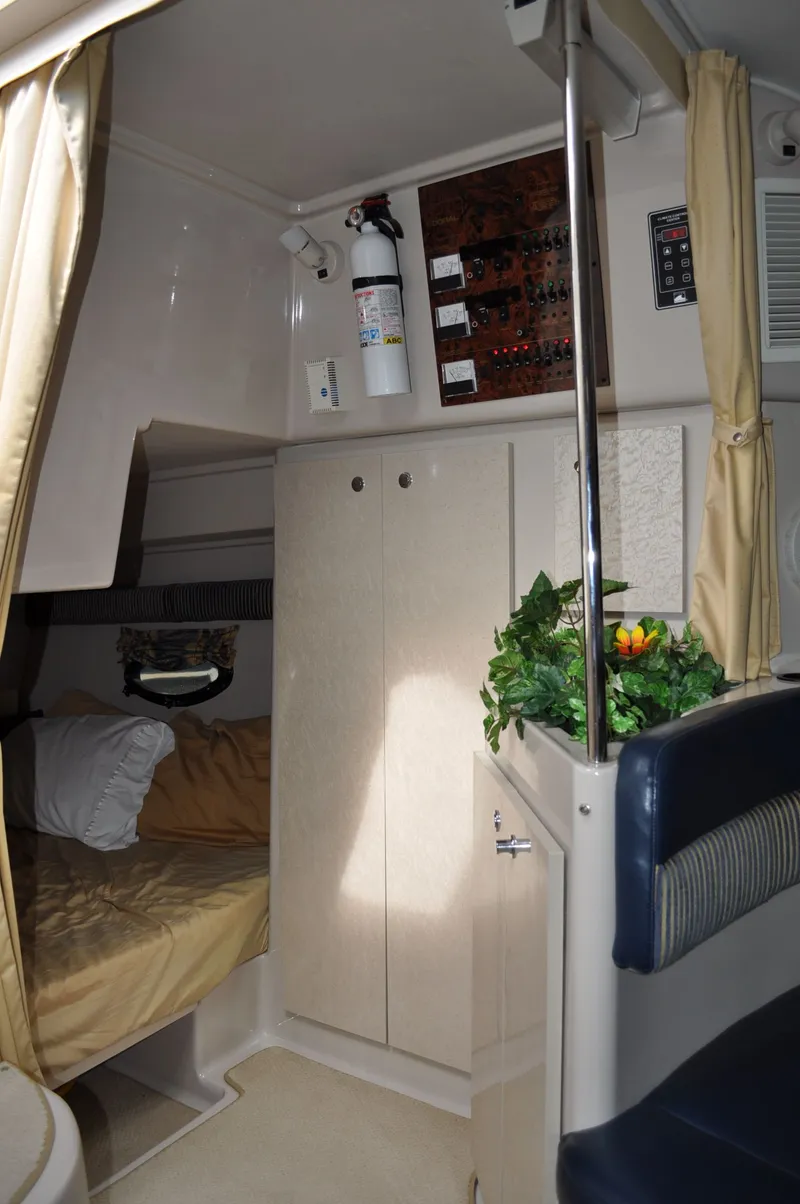 Slide: The Image of Interior of a 1999 Doral 350sc with sleeping area, cabinet, and plant arrangement. - 24