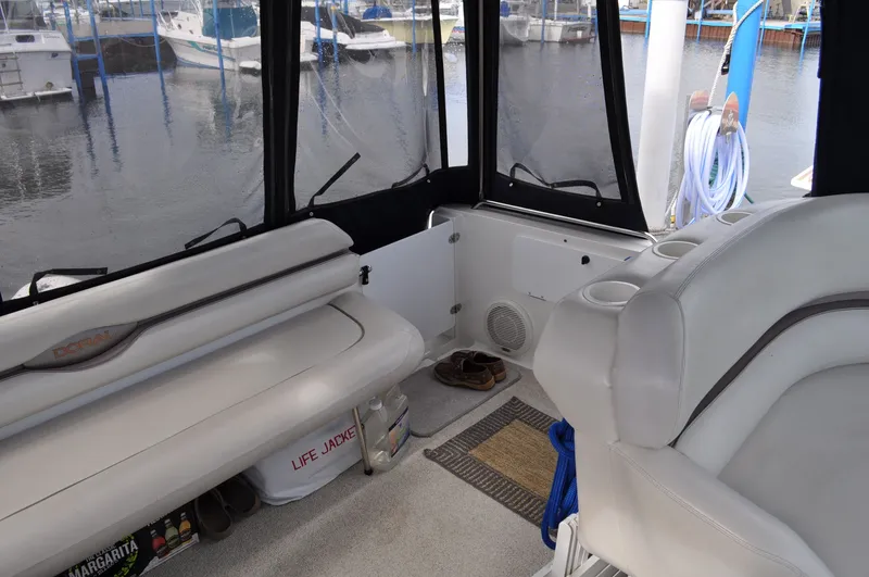 Slide: The Image of The image shows the cockpit of a 1999 Doral 350sc with white seating and a view of the marina. - 11
