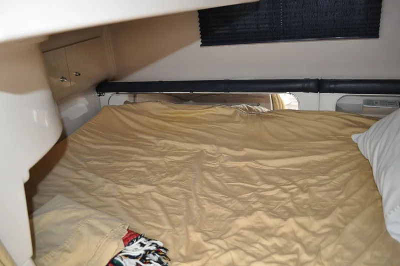 Slide: The Image of The image shows a cozy cabin with a double bed and a pillow. - 26