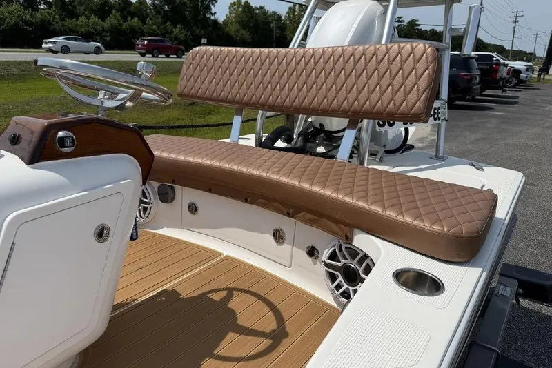 Slide: The Image of 2012 Chaos 16 Bonefish boat interior with diamond-stitched seating and modern steering wheel. - 19