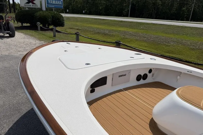 Slide: The Image of 2012 Chaos 16 Bonefish boat with teak deck and Simrad electronics, parked near Yamaha sign. - 9