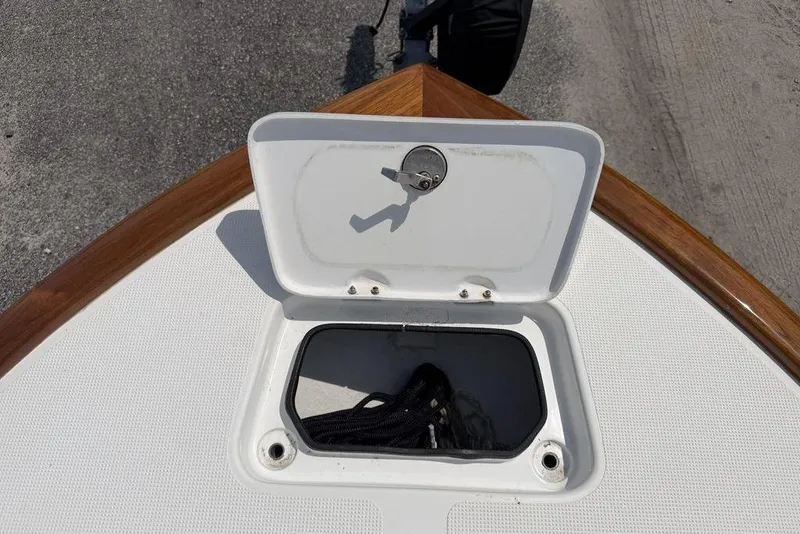 Slide: The Image of Open storage compartment on 2012 Chaos 16 Bonefish boat deck. - 11
