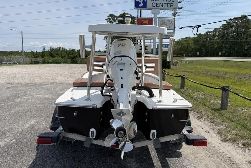 Slide: The Image of 2012 Chaos 16 Bonefish boat with outboard motor, parked near service center. - 7