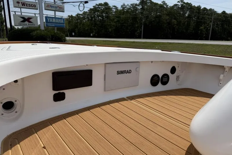 Slide: The Image of 2012 Chaos 16 Bonefish boat interior with Simrad electronics and teak flooring. - 20