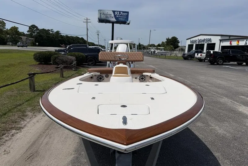Slide: The Image of 2012 Chaos 16 Bonefish boat with sleek design, parked outdoors near showroom. - 8