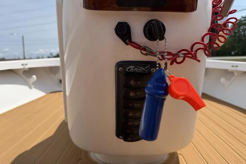 Slide: The Image of Control panel of a 2012 Chaos 16 Bonefish boat with safety whistle and lanyard. - 14