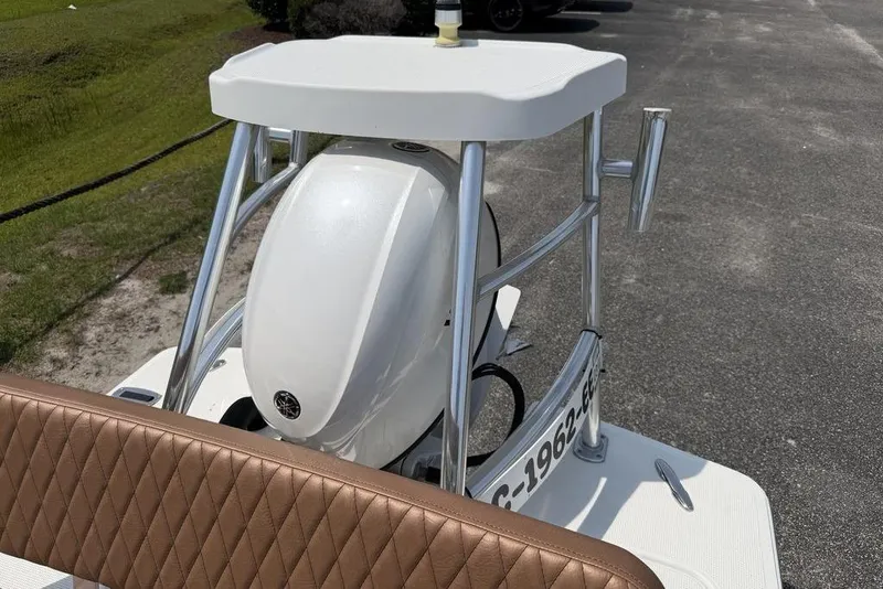 Slide: The Image of 2012 Chaos 16 Bonefish boat with Yamaha engine, featuring a sleek design and brown seating. - 12