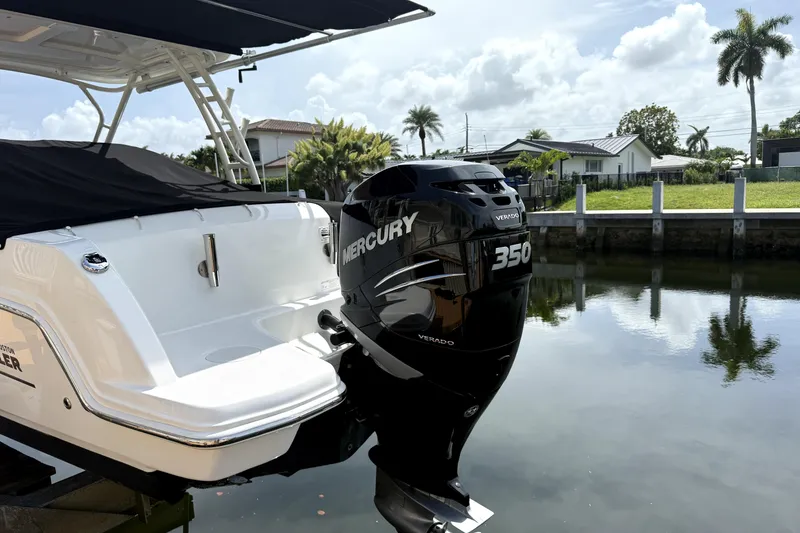 Slide: The Image of 2018 Boston Whaler 230 Vantage with Mercury 350 Verado engine docked by a canal. - 3