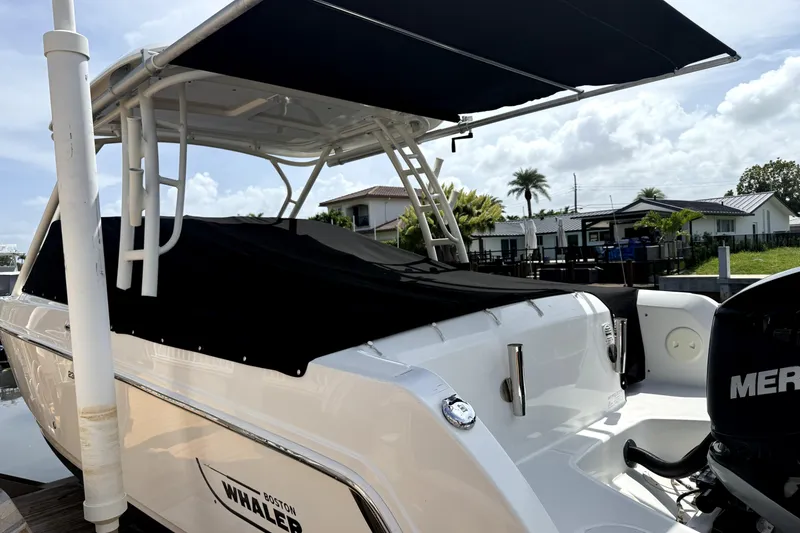 Slide: The Image of 2018 Boston Whaler 230 Vantage boat docked with canopy and Mercury engine. - 7