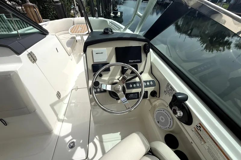 Slide: The Image of 2018 Boston Whaler 230 Vantage boat cockpit with steering wheel and control panel. - 14
