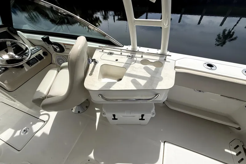 Slide: The Image of 2018 Boston Whaler 230 Vantage boat interior with helm, seating, and fishing station. - 13