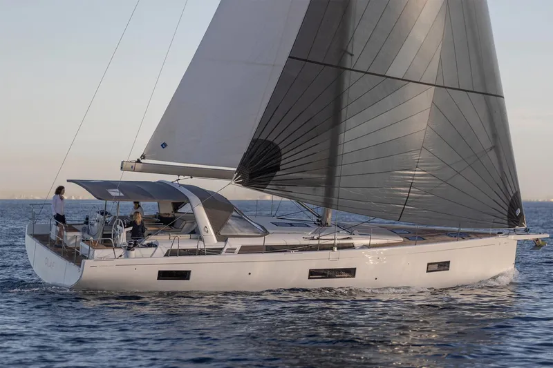 Slide: The Image of Manufacturer Provided Image: 2026 Beneteau Oceanis Yacht 54 sailing on calm waters at sunset. - 2