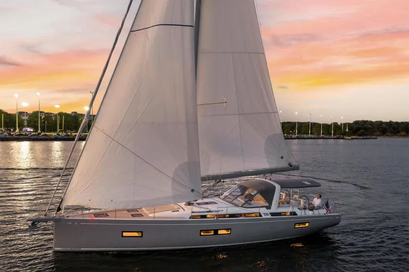 Slide: The Image of Manufacturer Provided Image: 2026 Beneteau Oceanis Yacht 54 sailing at sunset on calm waters. - 3
